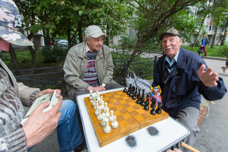 St. PETERSBURG, RUSSIA - SEP 2, 2017: Pensioners play chess in the courtyard of an apartment building. In Petersburg among the population the share of pensioners is approximately 24.4 percent.のeditorial素材