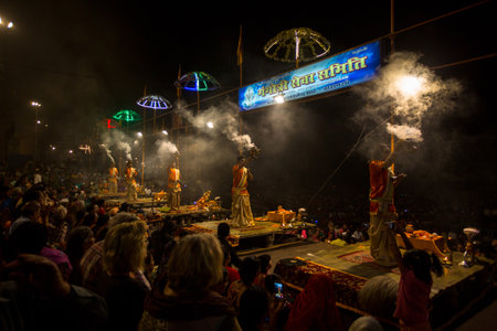 VARANASI, INDIA - MAR 20, 2018: Hindu priests perform Agni Pooja (Sanskrit: Worship of Fire) on Dashashwamedh Ghat - main and oldest ghat of Varanasi located on the Ganges.のeditorial素材