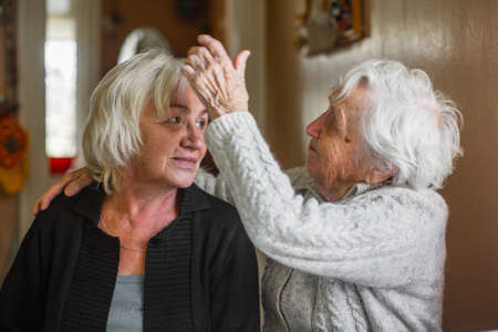 Portrait of an elderly woman with her adult daughter.の写真素材