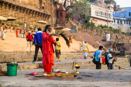 VARANASI, INDIA - MAR 21, 2018: Sadhu or Baba (holy man) on the ghats of Ganges river. Normally a sadhu is a monk, renounced, renounced material enjoyment. In India from 4 to 5 million sadhu.のeditorial素材