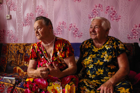 KURBA (VEPSIA) LENINGRAD.REG, RUSSIA - AUG 11, 2018: Vepsian local women in them rural home. Veps...