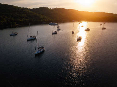 Aerial view of harbor with sailing yachts at the Sea during amazing sunset.の写真素材