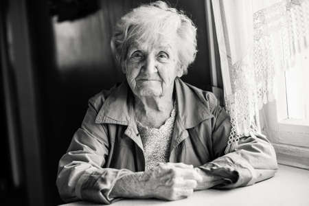 Monochrome portrait of an elderly woman.