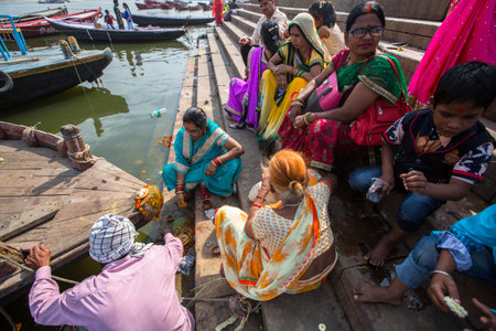 VARANASI, INDIA - MAR 16, 2018: Pilgrims on the banks of the Holy Ganga river. Varanasi is one of the most important pilgrimage sites in India and is one of the 7 sacred cities of Hinduism.のeditorial素材