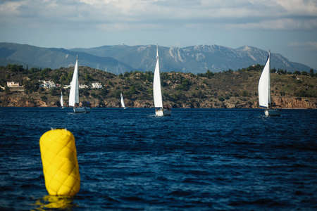 Sailing boats participate in sail yacht regatta in Aegean Sea, Greece Adventure and luxury holiday.