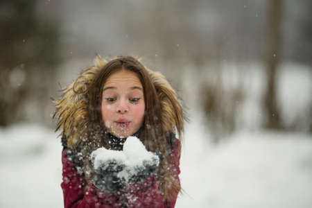 Little girl enjoys snow in amazing winter.の写真素材