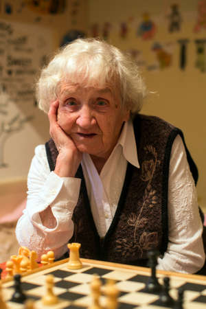 Portrait of an elderly woman playing chess.の写真素材