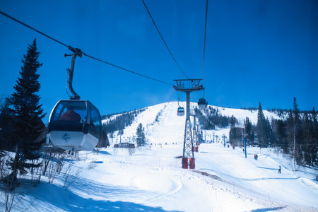 SHEREGESH, RUSSIA - MAR 10, 2019: View of the snow slope from the ski lift in the Mountain Shoria. It is now one of the most popular winter sports resort where more than million of tourist.のeditorial素材