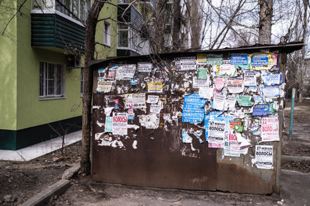 VORONEZH, RUSSIA - MAR 29, 2019: The wall is covered with old ads. At the moment city was on the...