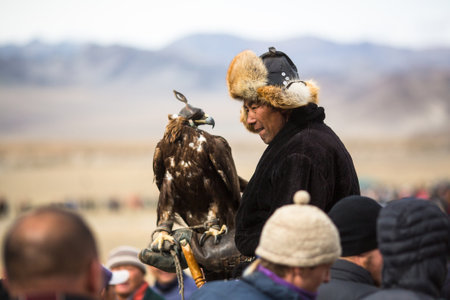 SAGSAY, MONGOLIA - SEP 30, 2017: Kazakh hunter to the hare with Golden eagle - Berkutchi, in the desert foothills of Western Mongolia.のeditorial素材