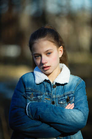 Portrait of a twelve year old cute girl outdoors.