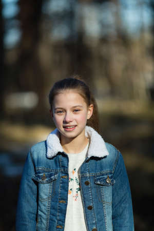 Schoolgirl's portrait in the spring outdoors.