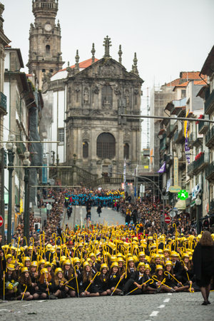 PORTO, PORTUGAL - MAY 7, 2019: During Cortejo Queima das Fitas - annual festivity of Portuguese students of universities. The graduates wear a top-hat and a walking-cane, both colour of their Faculty.のeditorial素材