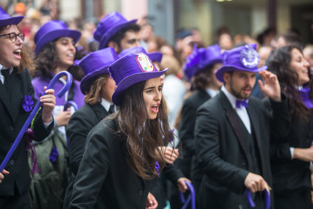 PORTO, PORTUGAL - MAY 7, 2019: During Cortejo Queima das Fitas - annual festivity of Portuguese students of universities. The graduates wear a top-hat and a walking-cane, both colour of their Faculty.のeditorial素材