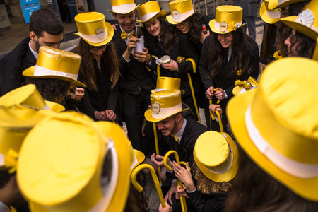 PORTO, PORTUGAL - MAY 5, 2019: During Queima das Fitas is a traditional festivity of Portuguese students of universities. The graduates wear a top-hat and a walking-cane, both colour of their Faculty.のeditorial素材