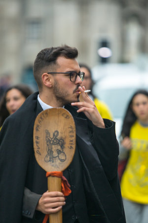 PORTO, PORTUGAL - MAY 7, 2019: During Cortejo Queima das Fitas - annual festivity of Portuguese students of universities. The graduates wear a top-hat and a walking-cane, both colour of their Faculty.のeditorial素材