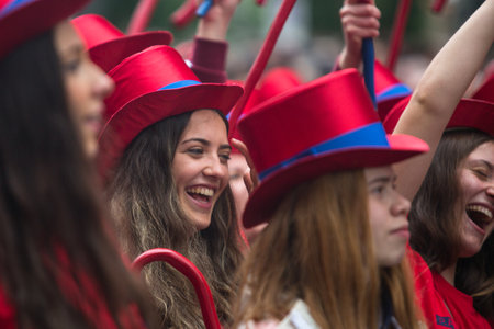 PORTO, PORTUGAL - MAY 7, 2019: During Cortejo Queima das Fitas - annual festivity of Portuguese students of universities. The graduates wear a top-hat and a walking-cane, both colour of their Faculty.のeditorial素材
