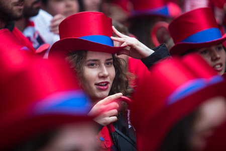 PORTO, PORTUGAL - MAY 7, 2019: During Cortejo Queima das Fitas - annual festivity of Portuguese students of universities. The graduates wear a top-hat and a walking-cane, both colour of their Faculty.のeditorial素材