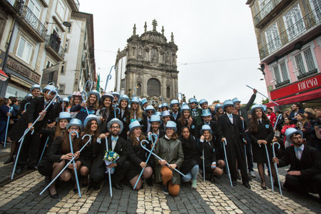 PORTO, PORTUGAL - MAY 7, 2019: During Cortejo Queima das Fitas - annual festivity of Portuguese students of universities. The graduates wear a top-hat and a walking-cane, both colour of their Faculty.のeditorial素材