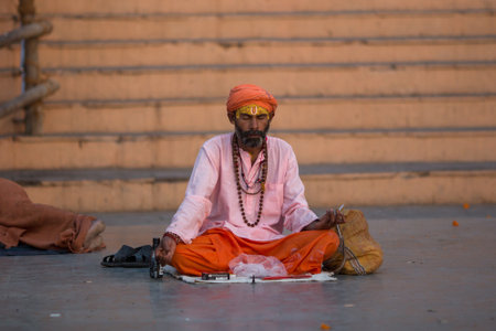 VARANASI, INDIA - MAR 21, 2018: Sadhu or Baba (holy man) on the ghats of Ganges river. Normally a sadhu is a monk, renounced, renounced material enjoyment. In India from 4 to 5 million sadhu.のeditorial素材