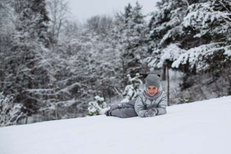 Portrait of a cute little girl in the winter outdoors in the snow.の写真素材