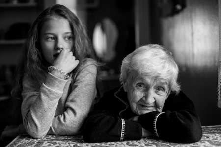 Child of eleven with his grandmother. Black and white photo.の写真素材