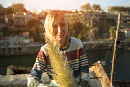 Young woman with an spikelet in his hand.の写真素材