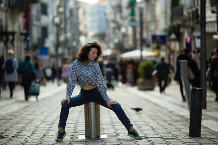 Beautiful mixed-race woman posing in the street of Porto center, Portugal. の写真素材