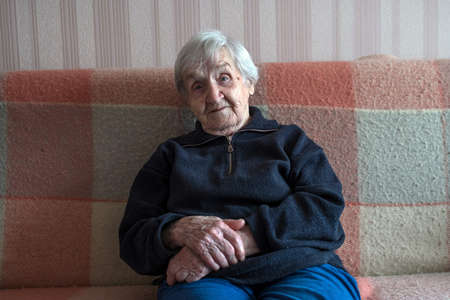Portrait of an old woman gray-haired russian pensioner.