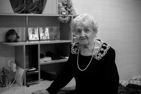 An old woman in a room, a black-and-white photo.の写真素材