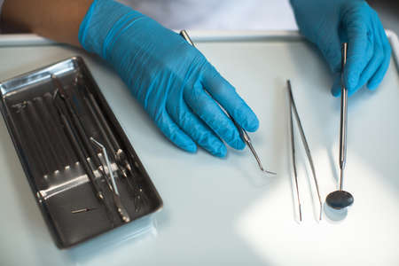 Close-up hands female dentist with dental instruments.の写真素材