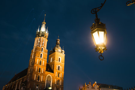 St. Mary's Church on the Krakow Market Square in night time, Poland.のeditorial素材