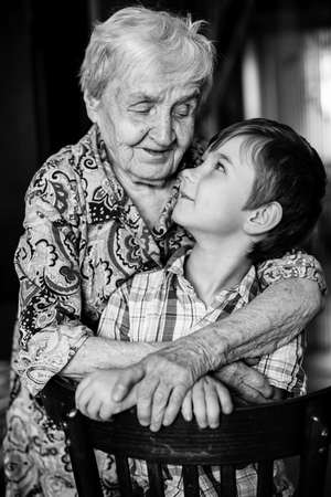 Grandmother and grandson posing for the camera. Black and white photography.の写真素材