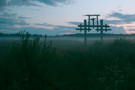 Green field with an ancient totem at dusk, Northern Russia.
