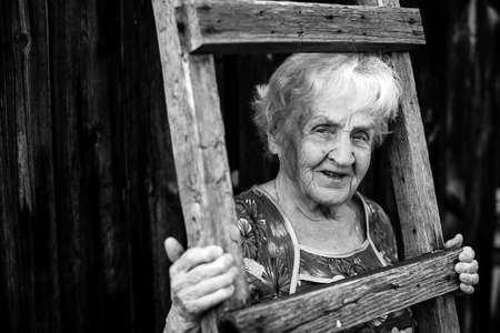 An old woman portrait in the village. Black and white photo.の写真素材