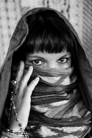 Portrait of a woman covering her face with a veil. Black and white photo.の写真素材