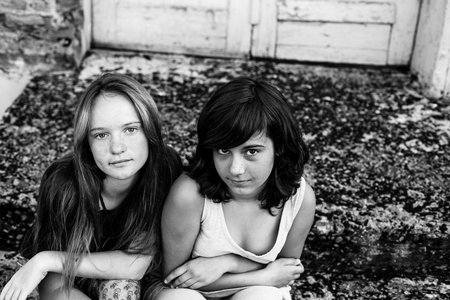 Two teenage girl friends outdoor. Black and white photo.