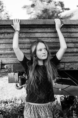 Young cute girl standing near the old truck. Black and white photo.の写真素材