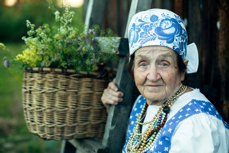 Portrait of old woman in ethnic clothes in the russian village.の写真素材