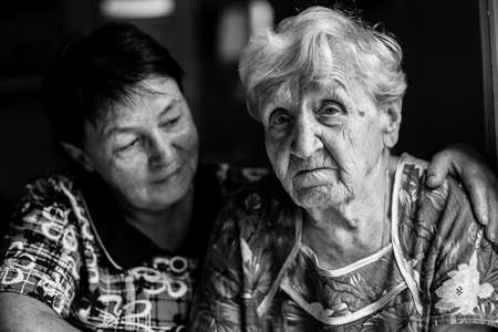Portrait of a old woman with adult daughter. Black and white photo.の写真素材