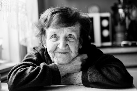 Portrait of an old woman in her home. Black and white photo.の写真素材