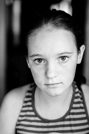 Portrait of a teenage girl in her home. Black and white photo.