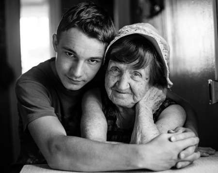 Portrait of old woman with her grandson. Black and white photo.の写真素材
