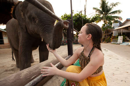 Teenage girl with a young elephant, Koh Chang Island, Thailand.の写真素材