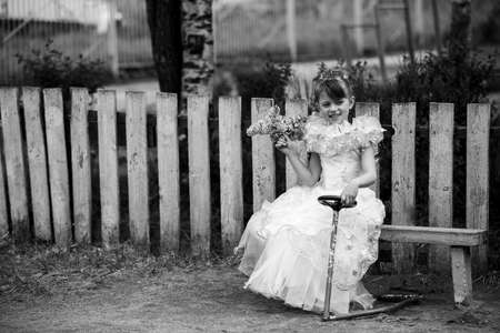 Little girl on the street. Black and white photo.の写真素材