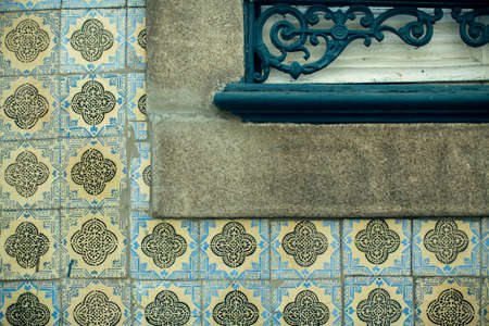 Traditional old tiles wall of building on street painted tin-glazed, azulejos ceramic tilework....