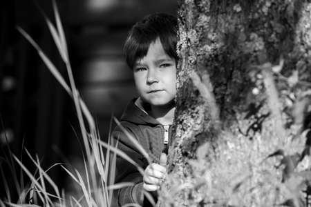 A portrait of a five-year-old boy lies in the Park. Black and white photo.の写真素材