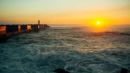 View of the ocean pier with the surf during a stunning sunset.の写真素材
