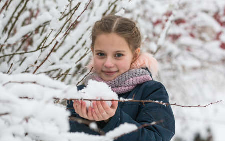 Portrait of little cute girl in the Park at winter.
