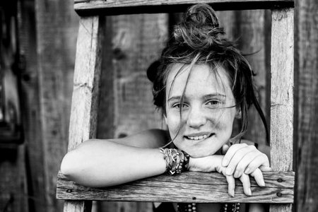 Girl portrait with hippie jewelry in rural surroundings. Black and white photo.の写真素材
